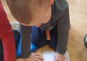 Chłopiec rysuje receptę na pozytywne myślenie.